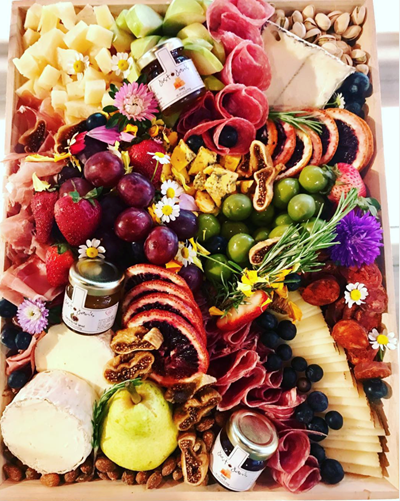 Delicious cheese board with meats, crackers, olives, nuts + paring jams 